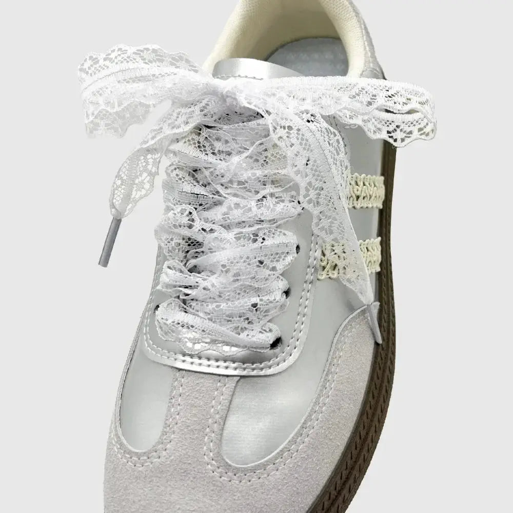 Women's lace-up shoelaces for sneakers; white flat laces tied in a bow on a light sneaker