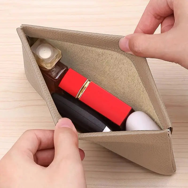 Artificial leather tan long wallet with inner slots holding lipstick and perfume bottle
