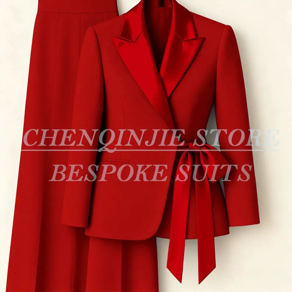 Red women's 2-piece suit set with peak-lapel blazer and matching pants, belted waist bow.