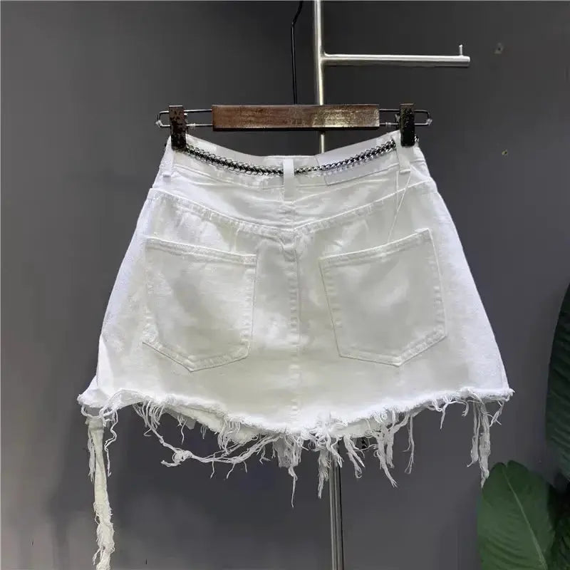 White denim mini skirt with raw frayed hem, two back pockets, chain belt.