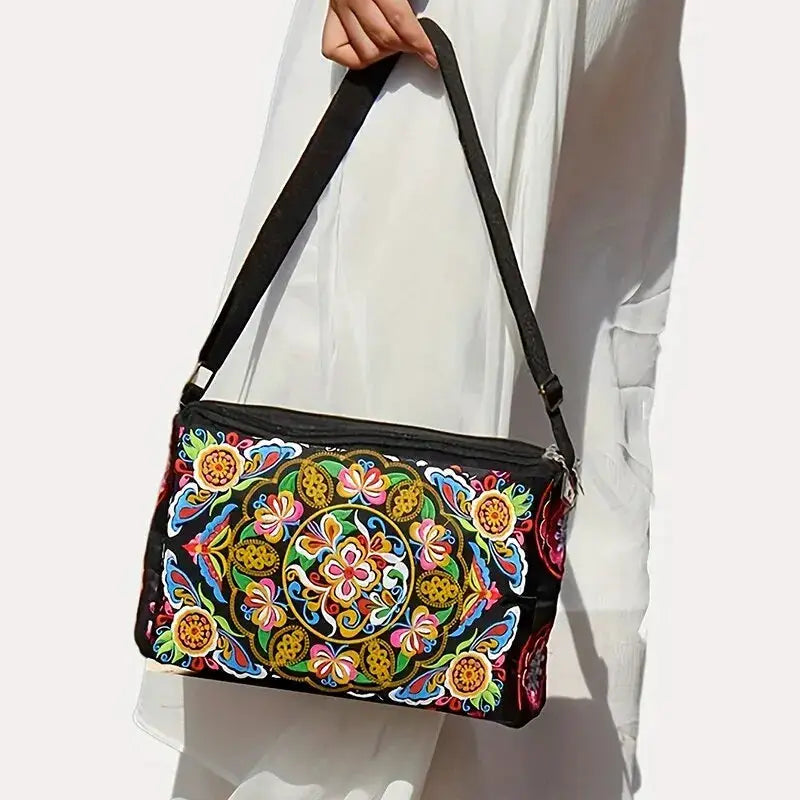 Crossbody bag with vibrant embroidered flowers on black nylon; large capacity travel shoulder bag