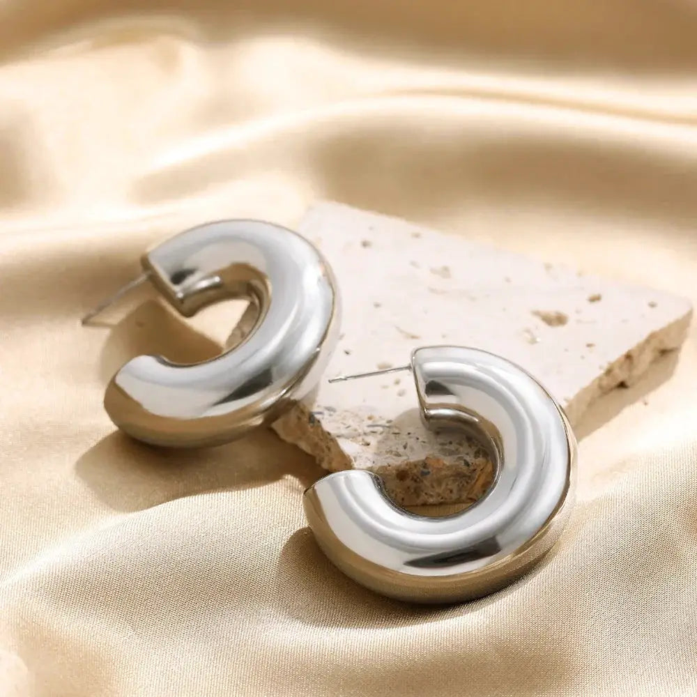Chunky silver-tone hoop earrings, C-shaped thick circle design for women, fashion jewelry.