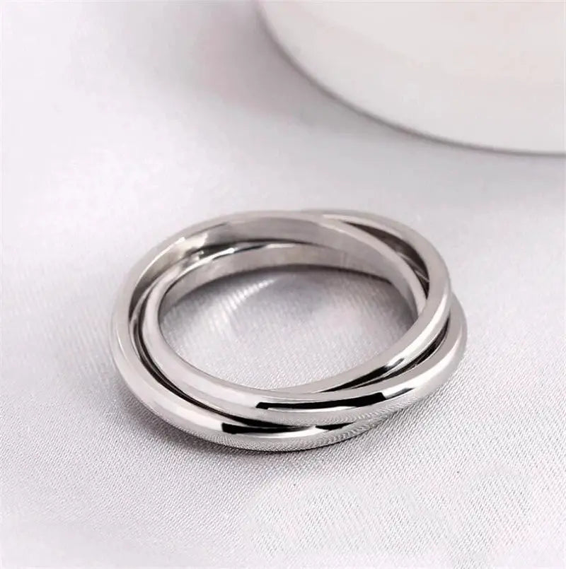 Stainless steel spinner ring with double-band design, highly polished silver finish, close-up shot detail