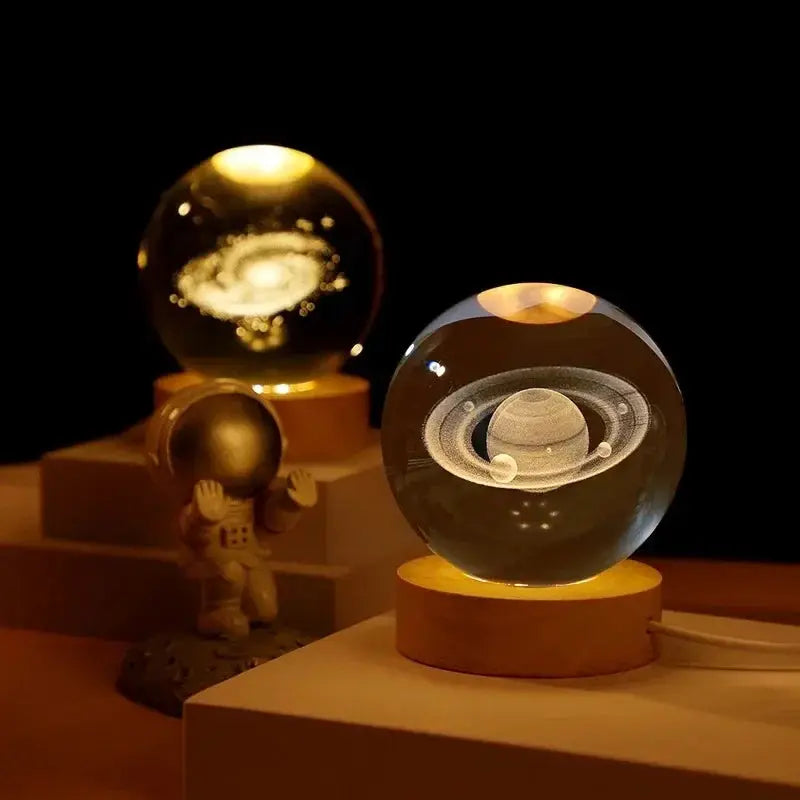 Two 3D crystal ball night lights on wooden bases with laser-engraved solar system globes; warm glass decor