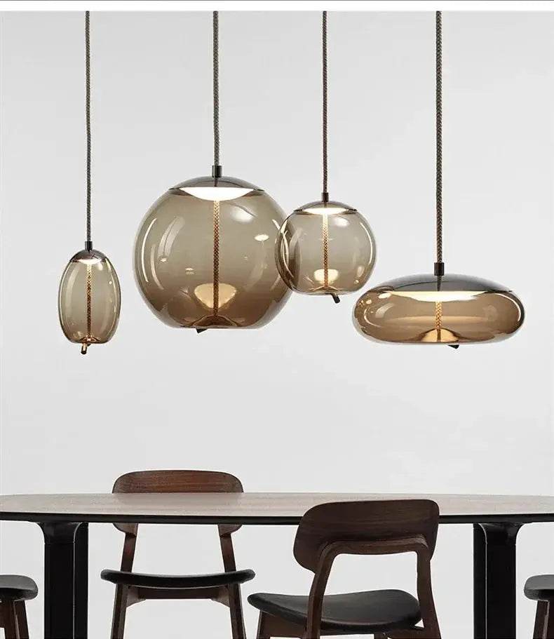 Pendant lamp set by Simples Market: four amber glass pendants with hemp rope cords over a dining table