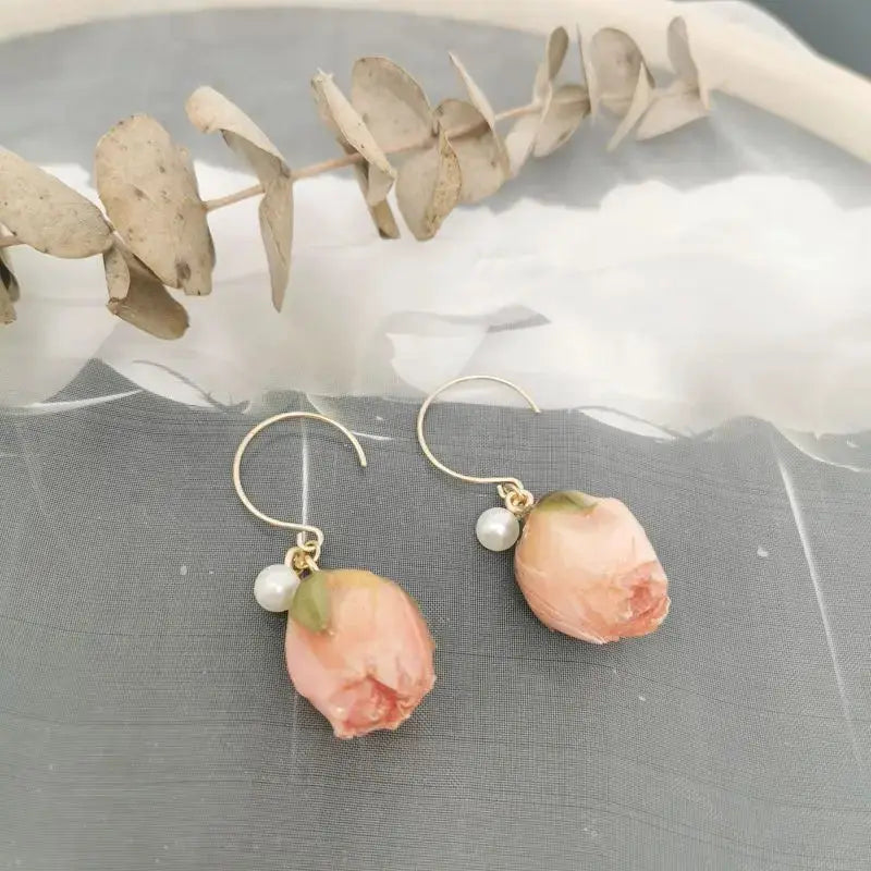 Red rose epoxy resin drop earrings with pearl accents and gold hooks