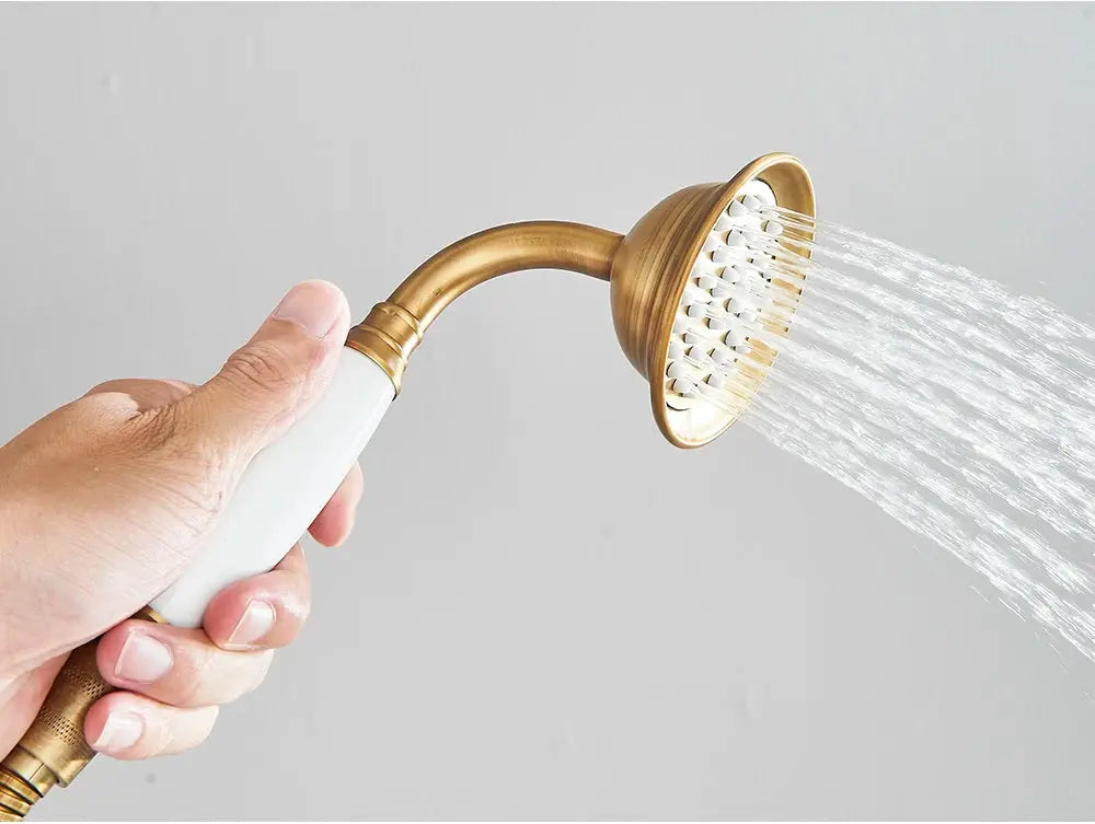 Antique brass handshower with white ceramic grip and 150cm hose