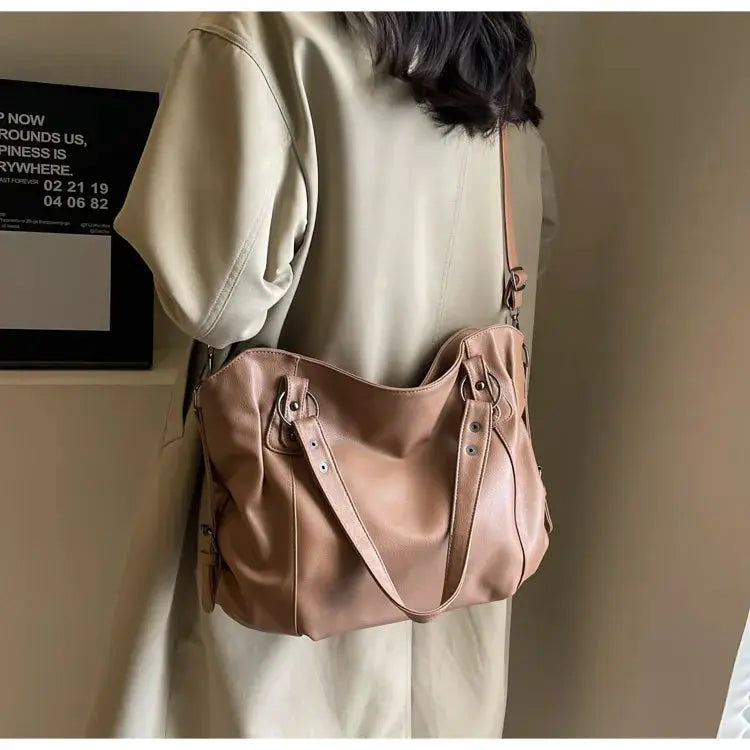 Soft interior compartment shoulder bag in tan PU leather with dual top handles and long strap