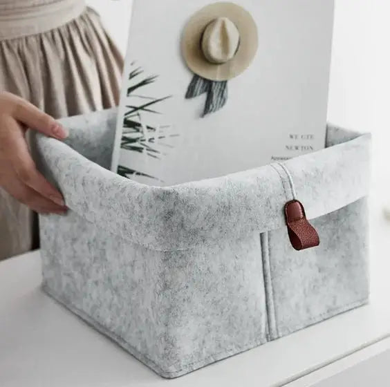 Felt storage basket by Simples Market in light gray with brown leather strap