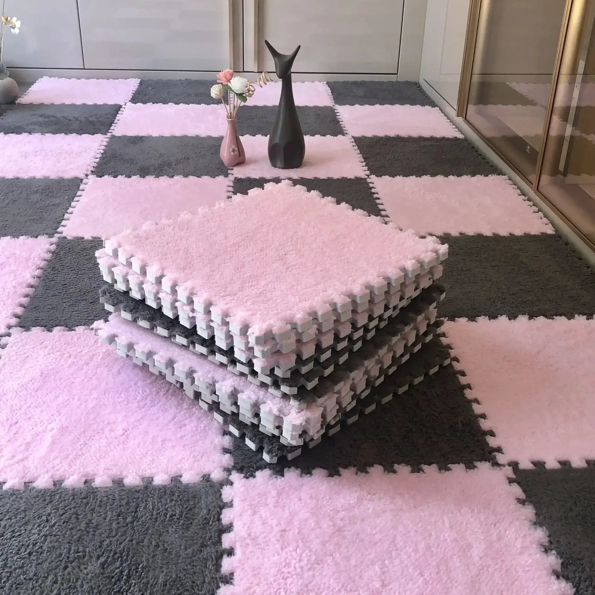 Simples Market soft plush EVA foam puzzle mat for kids, pink and gray interlocking tiles on the floor.