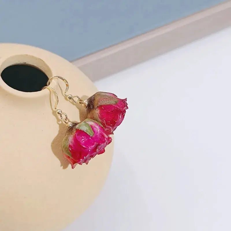 Rose drop earrings pair with pink-red epoxy resin rose blooms and gold-tone hooks