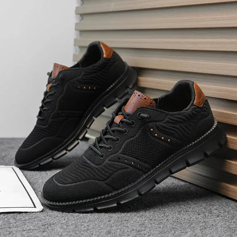 Pair of plus-size men's black mesh sneakers with brown leather accents, breathable non-leather casual shoes