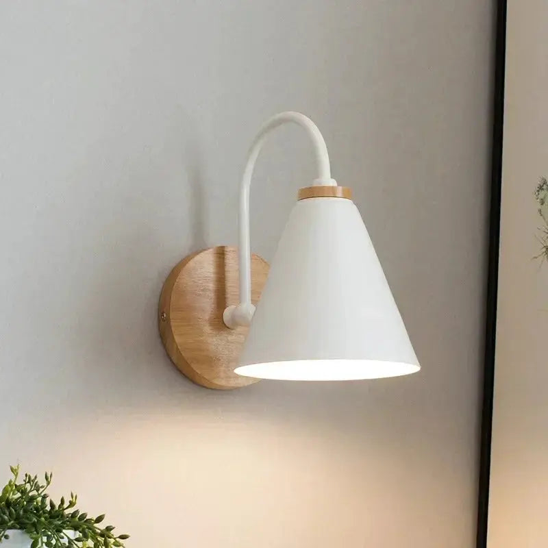 Nordic wall sconce lamp with white cone shade and wood backplate.