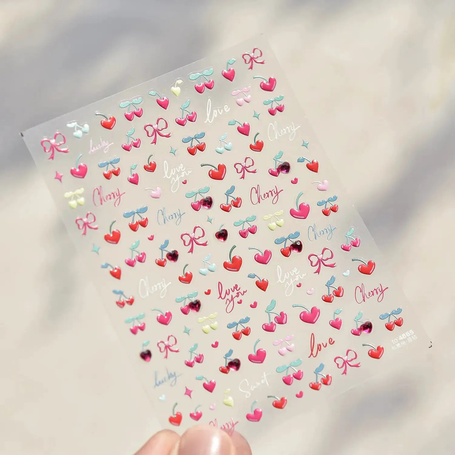 Self-adhesive nail art stickers sheet in pink translucent peach jelly texture with 5D embossed cherries, hearts and bows