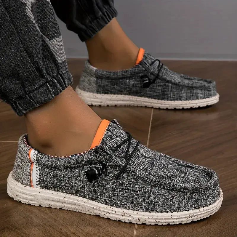 Men's gray canvas loafers with orange trim and speckled white sole by Simples Market