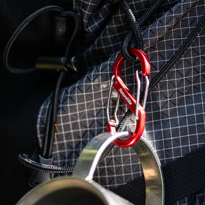 Naturehike S-shaped mountaineering buckle with red aluminum carabiner on a backpack strap
