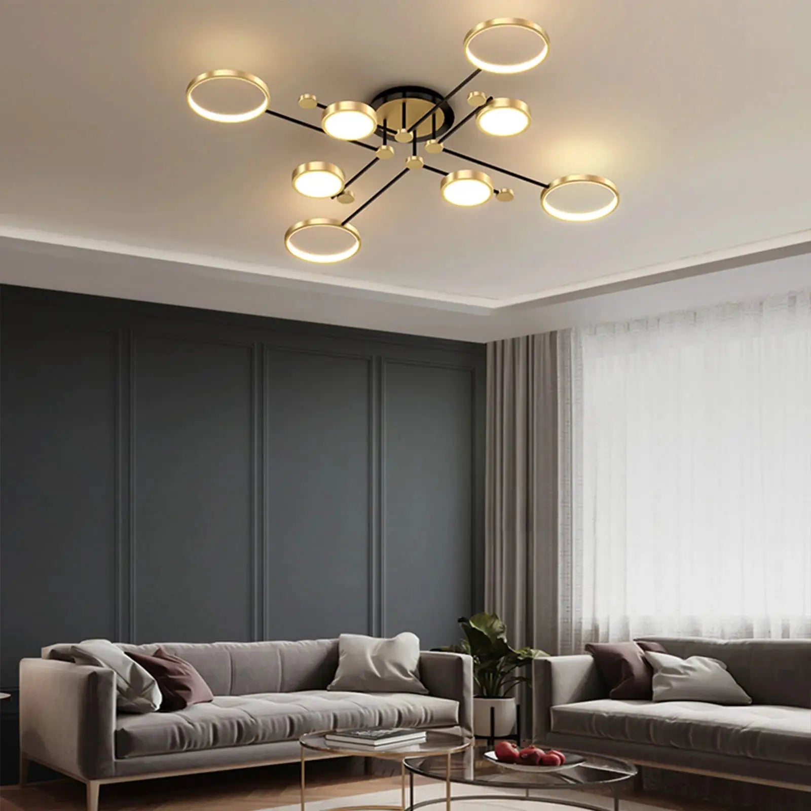 Modern gold LED chandelier with circular ring lights on black arms for living room ceiling