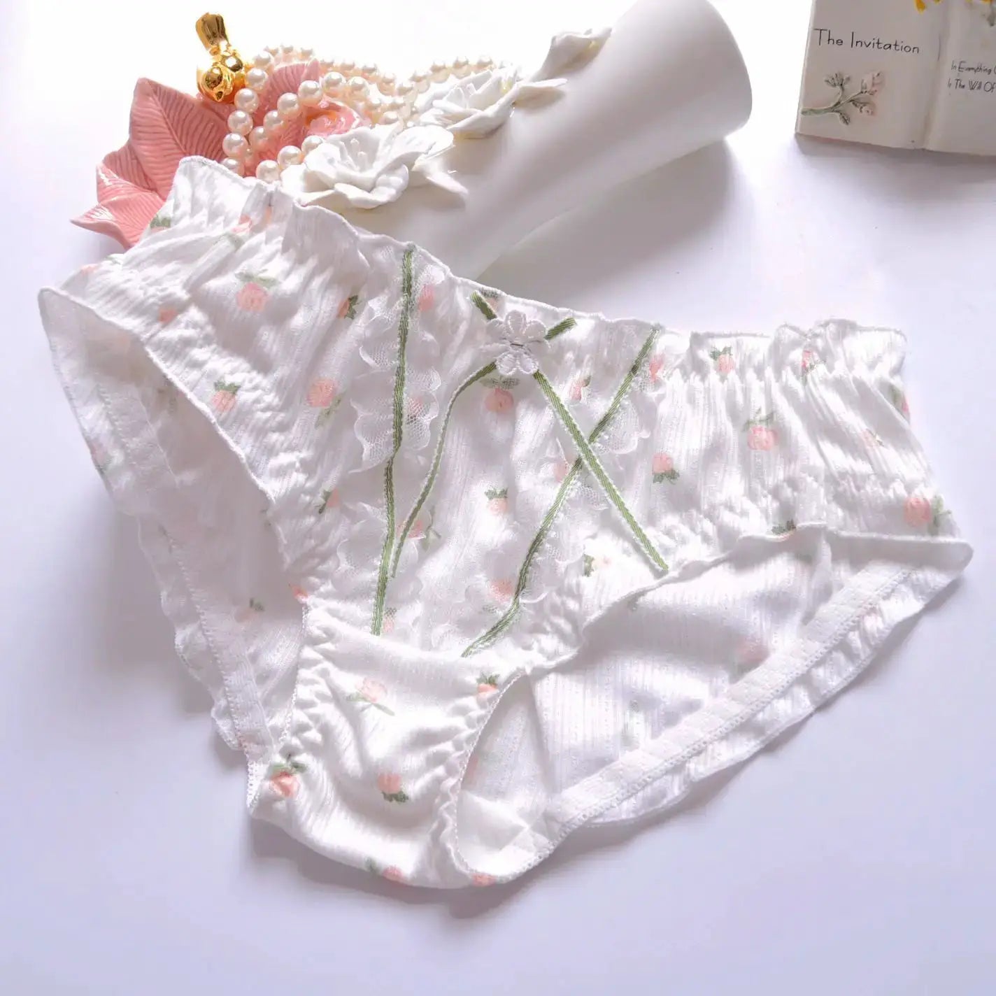 Cotton floral panties with lace trim and green embroidery on white fabric