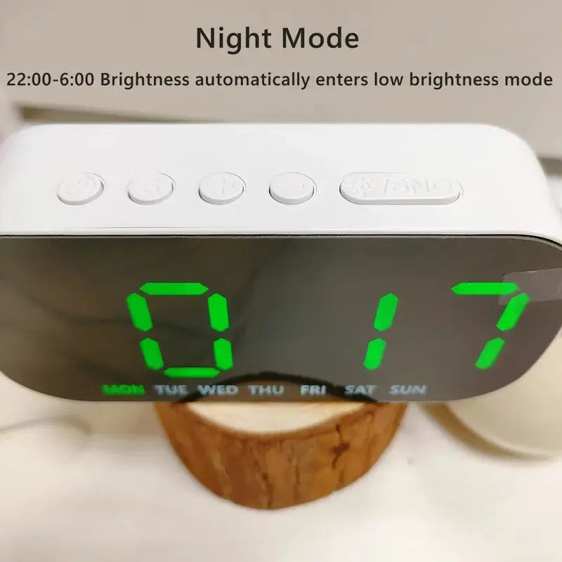 Digital alarm clock, white USB-powered with green LED time display and day-of-week indicators.