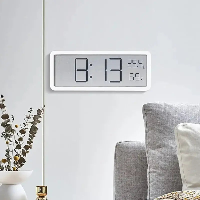 White LCD wall clock displaying time, temperature and humidity