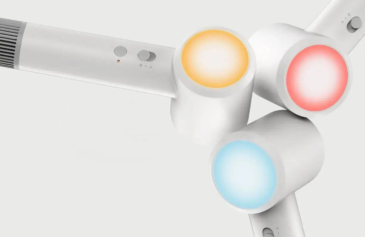 MIJIA H501 SE hair dryer by Simples Market; white handheld unit with three color-lit circular ends (orange, blue, red).
