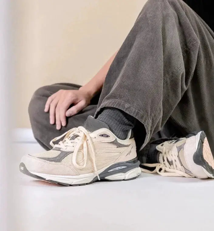 Beige mesh running shoes pair with gray overlays, retro 990 style, anti-slip sole