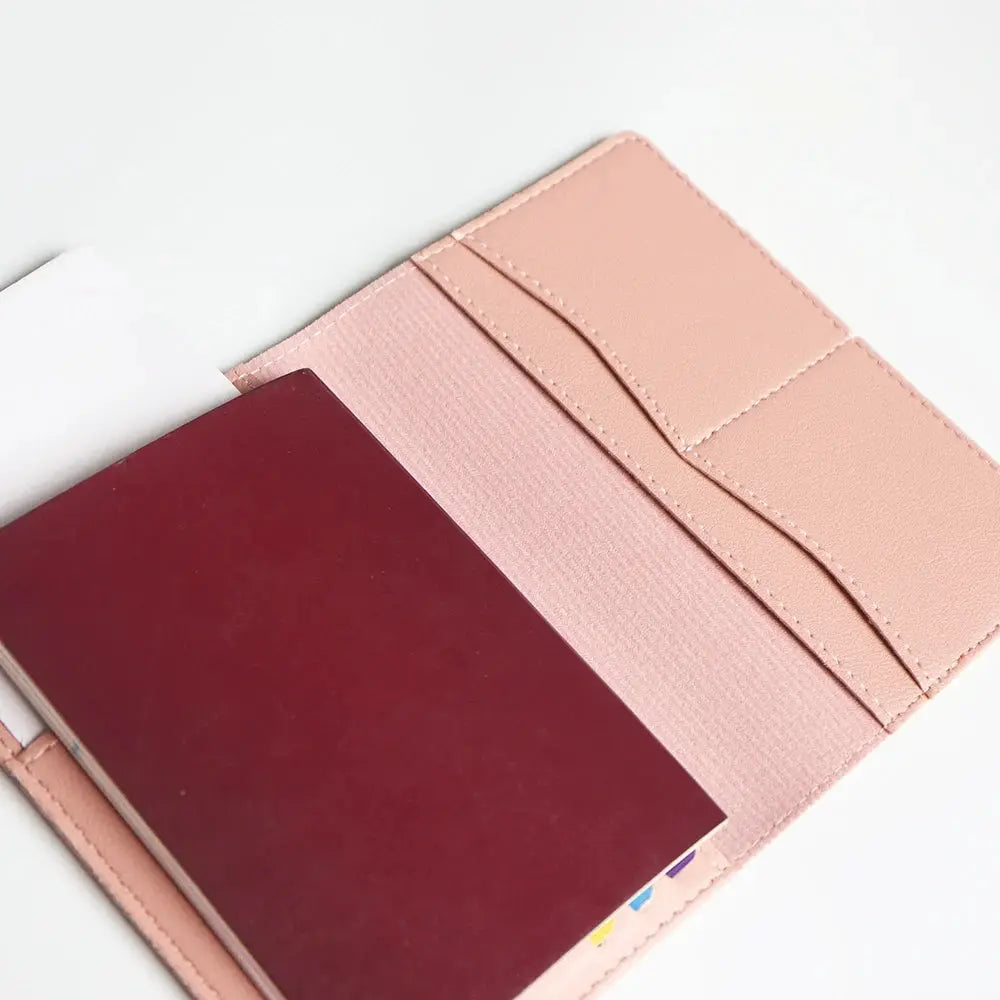 Pink travel passport cover set with card slots and burgundy passport inside