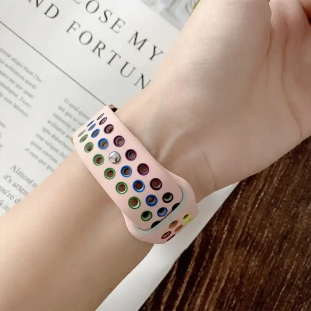 Silicone sport band for Apple Watch in pink with rainbow perforations, Pride design, fits 38–45mm