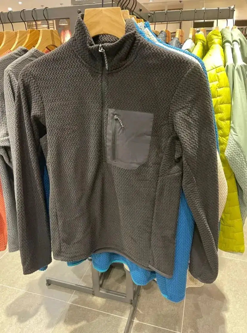 Fleece sweatshirt, gray with wavy texture, unisex, quarter-zip collar and front chest zip pocket.
