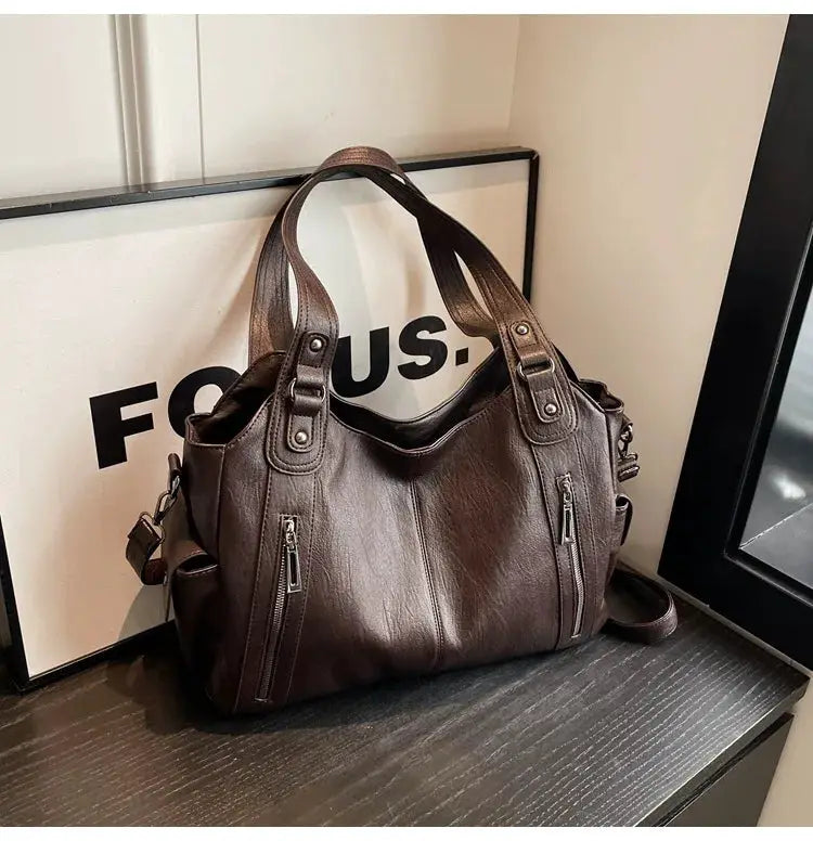 Brown PU leather shoulder bag with dual handles and front zipper pockets