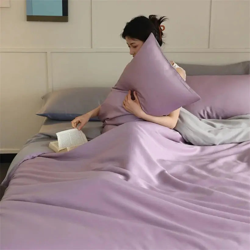 Mulberry silk bedding set by Simples Market in lavender on bed with pillowcases and sheets.