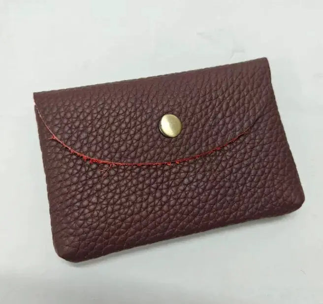 Simples Market burgundy genuine leather card holder with brass snap and red curved stitching