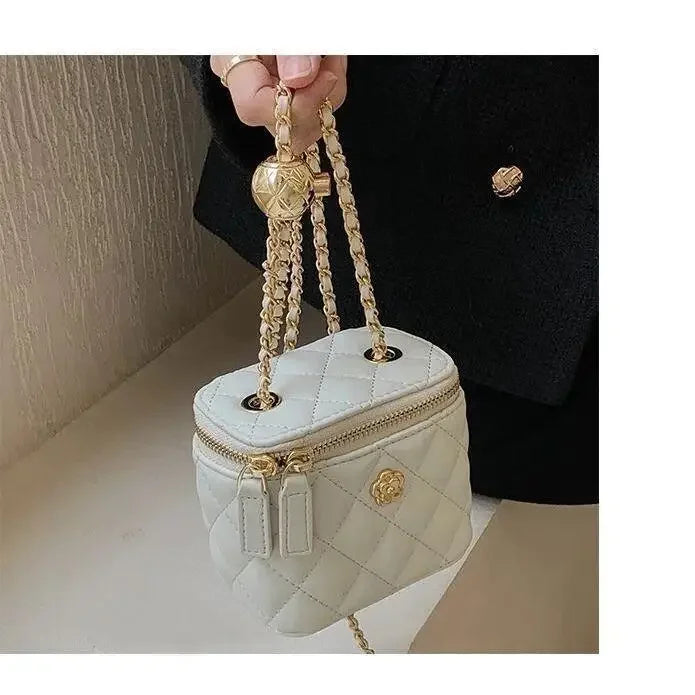 Mini white quilted box shoulder bag with gold chain strap and rose emblem