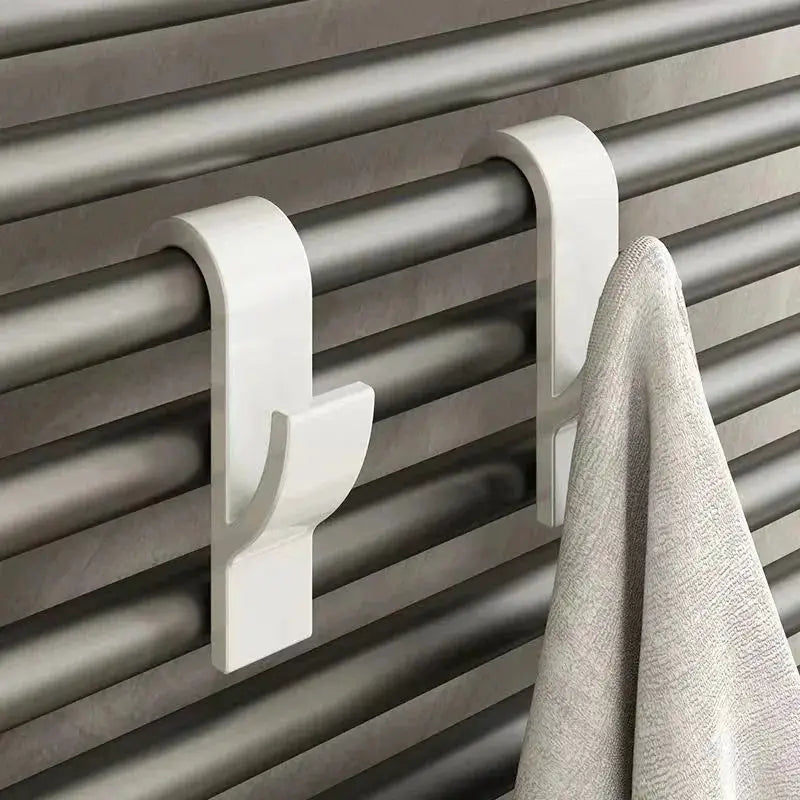 Simples Market white metal towel rail hooks clipped to a radiator with towel hanging