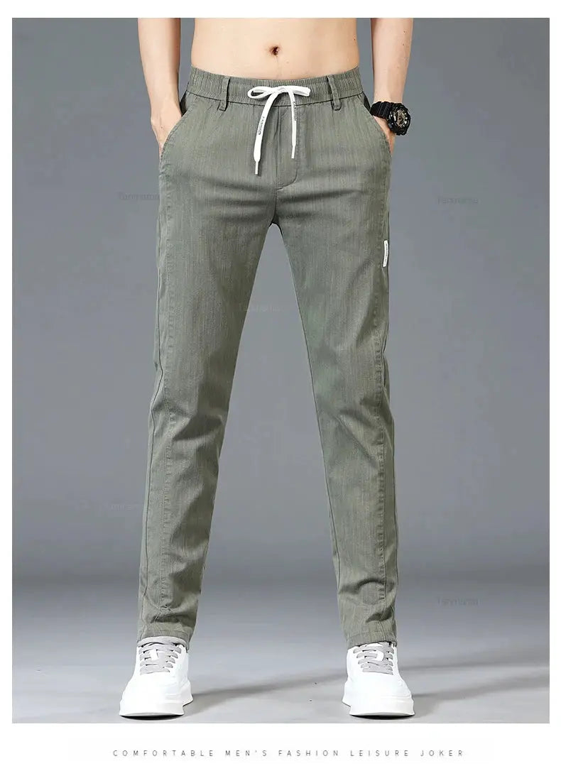 Men's slim straight casual pants with elastic drawstring waist in olive green; side pockets and zip thigh pocket.