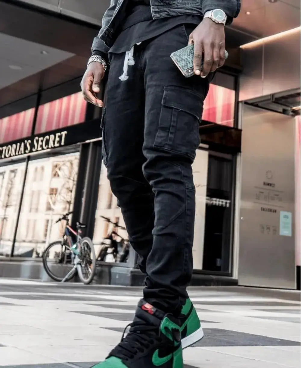 Men's black denim cargo pants with multiple pockets, streetwear jogger style