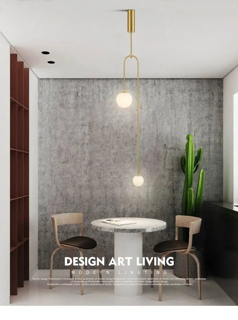 Nordic minimalist gold pendant chandelier with two globe bulbs along a vertical line.