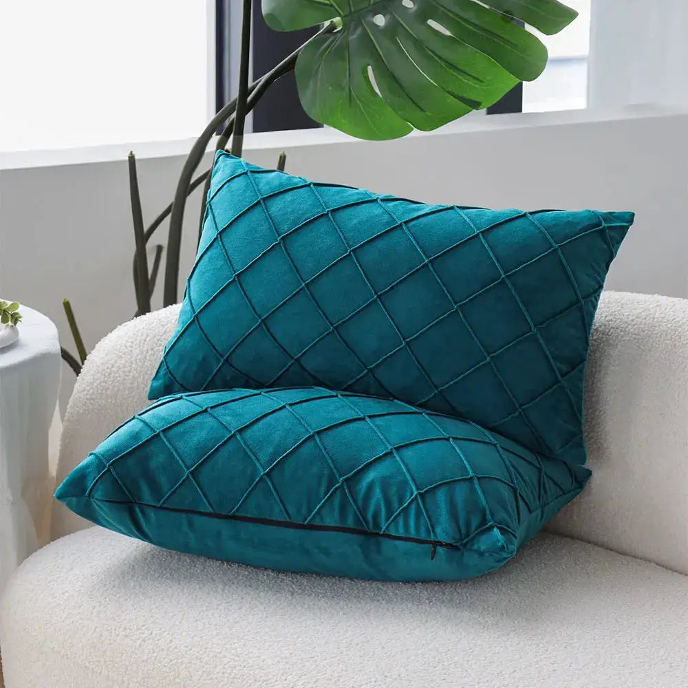 Pillow covers teal blue 30x50, two quilted velvet cushions with diamond grid pattern.