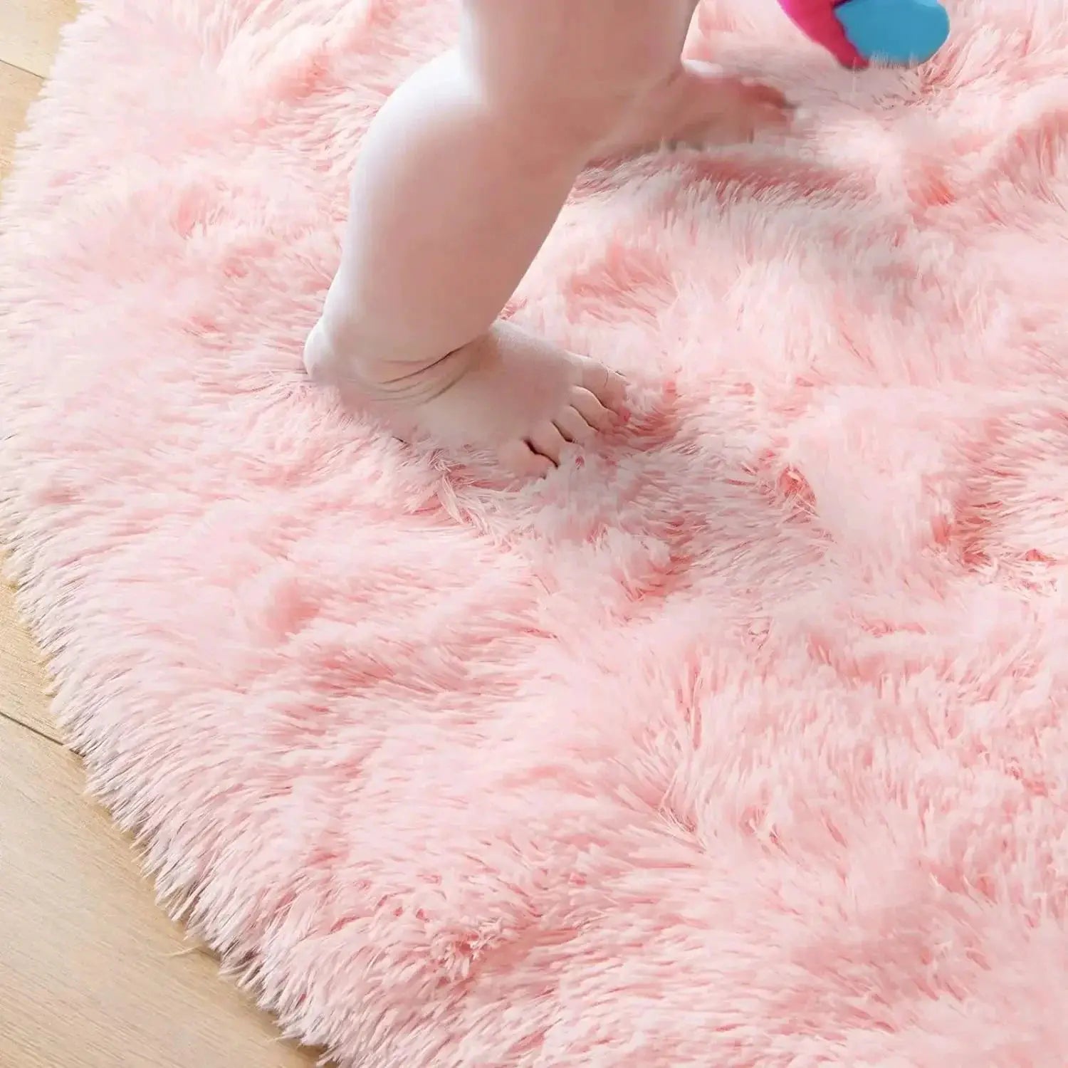 Pink fluffy plush round rug mat by Simples Market with thick pile for living room or kid room decor