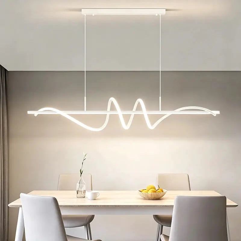 Modern LED pendant light with white wave-shaped bar over dining table