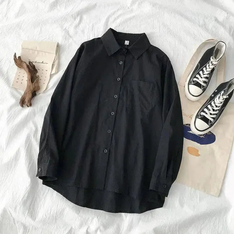 Black oversized long-sleeve button-down shirt with chest pocket and turn-down collar.