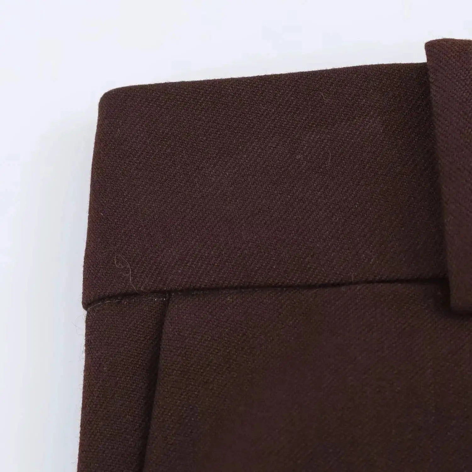 Brown blazer close-up showing textured fabric and lapel seam