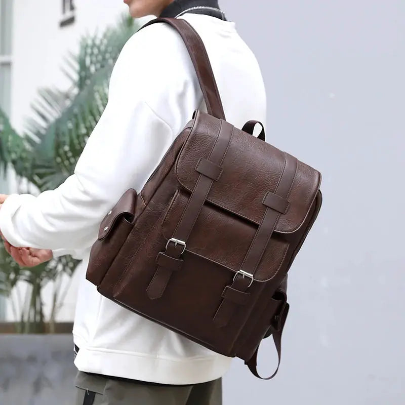 Backpack in brown PU leather for men with front buckle straps and a side pocket
