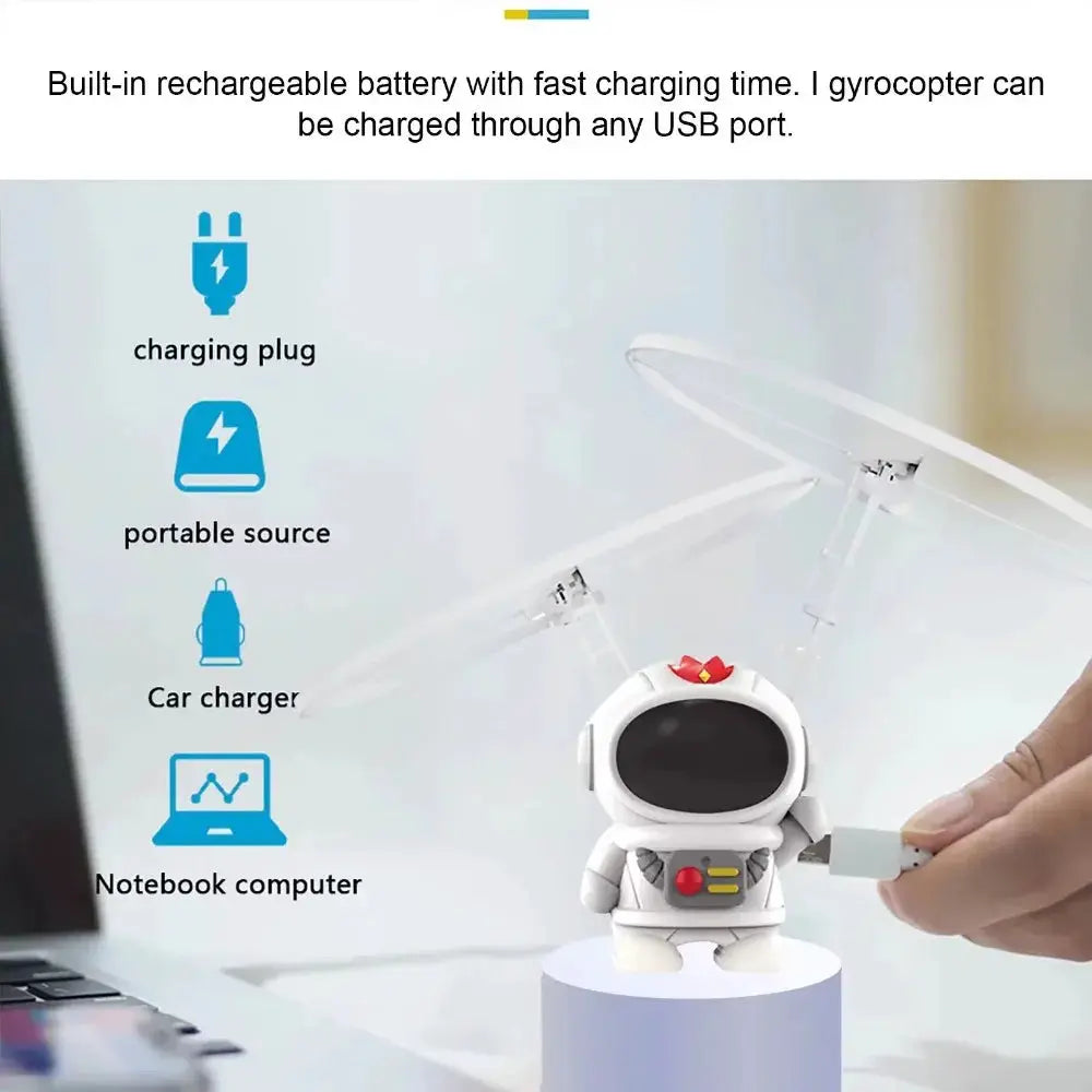 Levitating luminous flying robot astronaut toy, white figure with black visor, hand-controlled drone with lights.