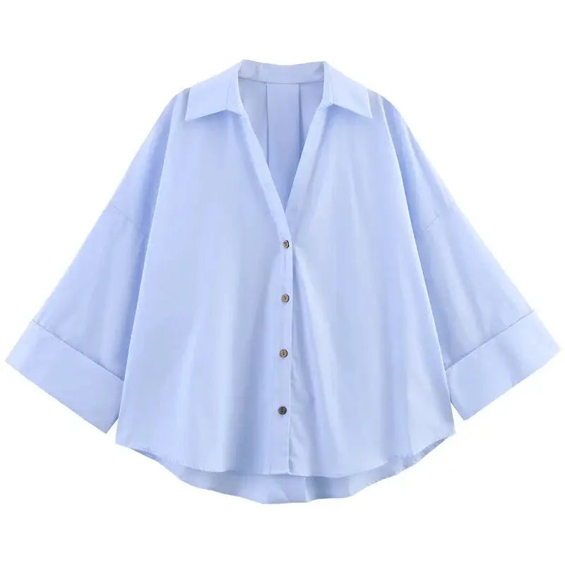 Light blue oversized women's collared button-down shirt with long sleeves.