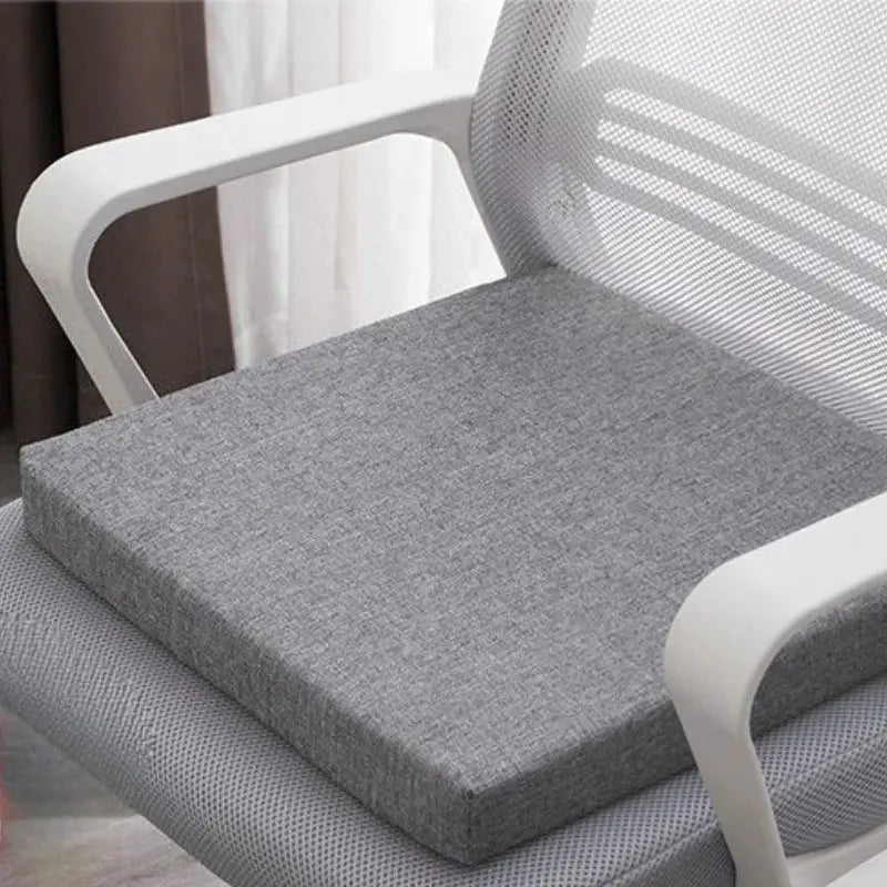 SRETNO natural latex chair cushion on a gray office chair; thick rectangular seat pad.