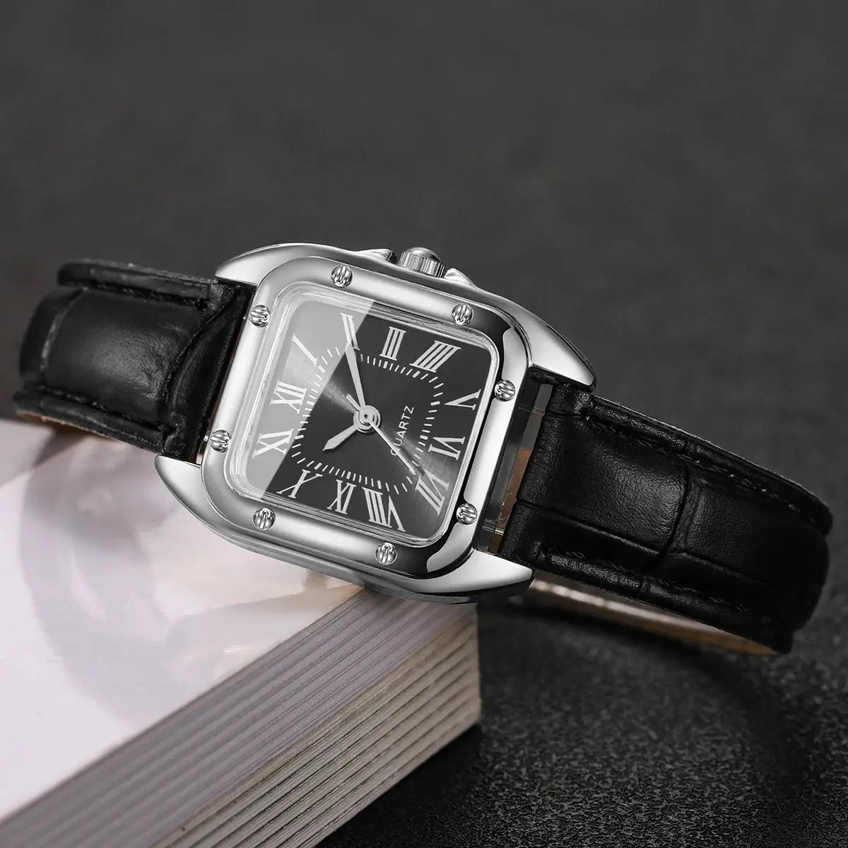 Fashion square women's quartz watch with black dial, Roman numerals, silver case, and black leather strap