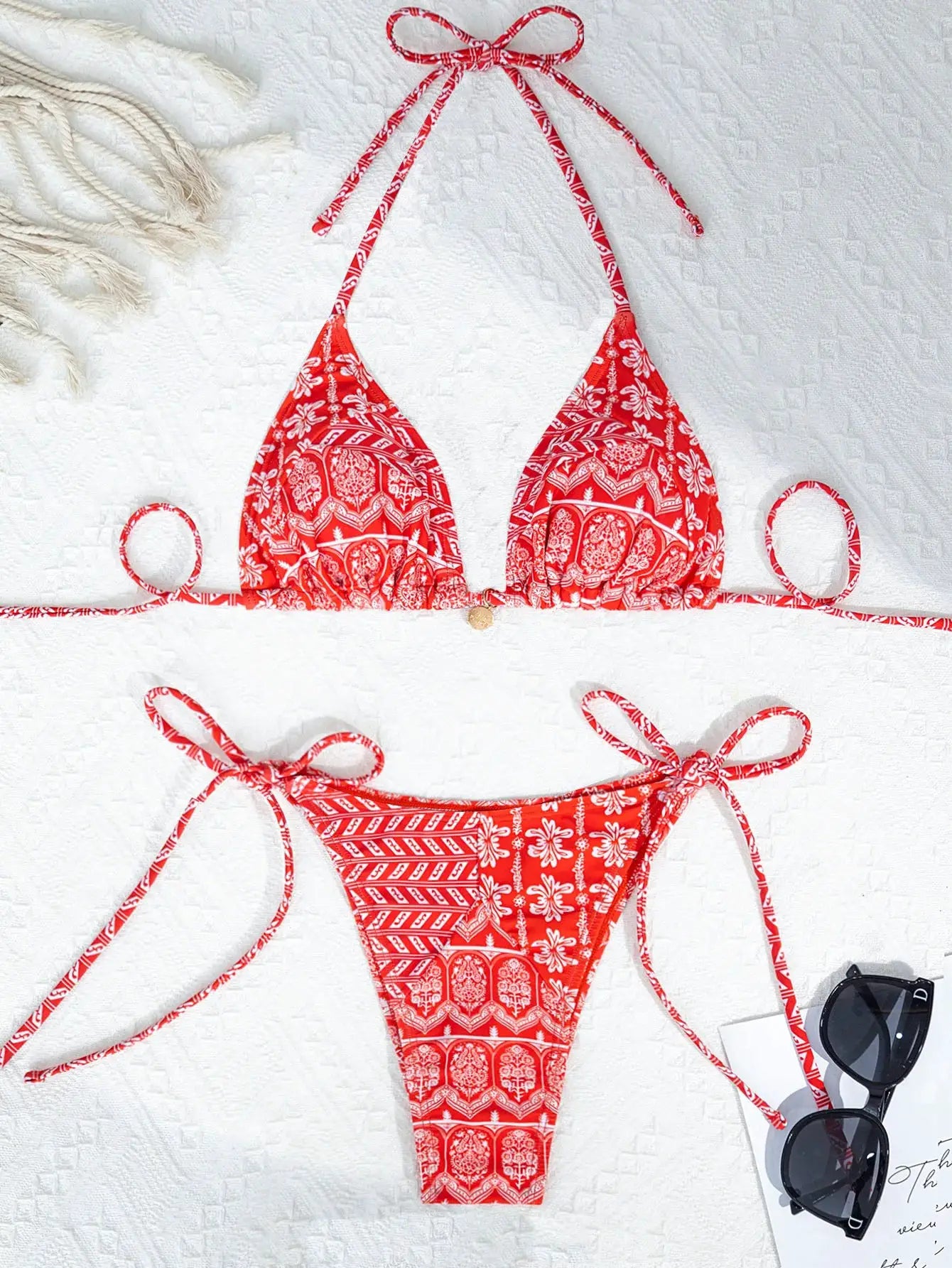 Women's red and white patterned bikini set with triangle top and adjustable tie-side bottoms