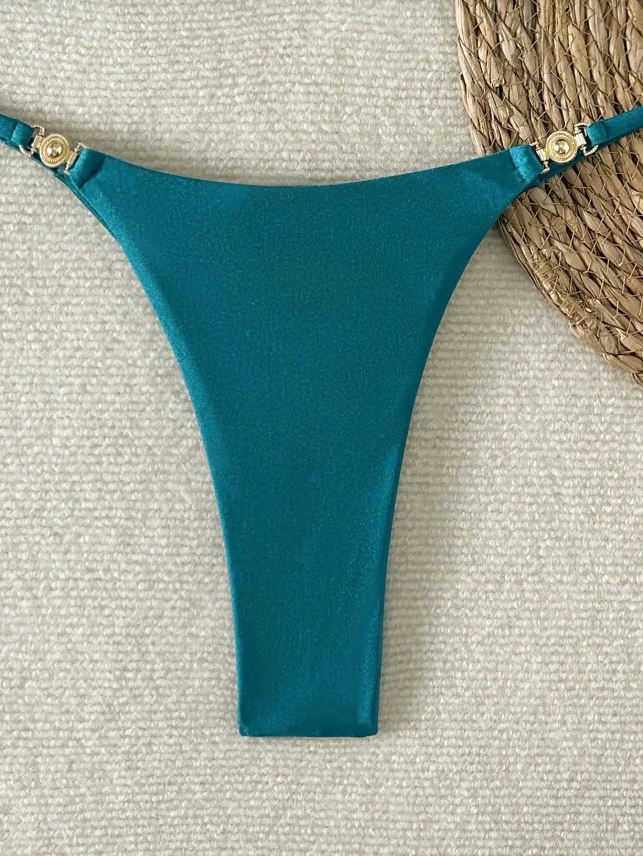 High-cut teal bikini bottom with gold-tone side hardware.