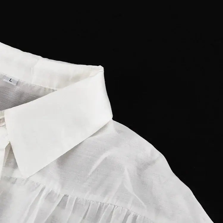 White collared shirt, solid color with crisp collar, close-up view